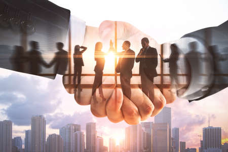 Abstract handshake on creative city background with businesspeople and toning. Teamwork and success...