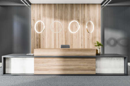 Bright wooden and concrete office lobby interior with reception desk and decorative items. 3D...