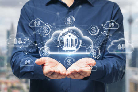 Close up of businessman hands holding abstract glowing cloud computing and online banking hologram...