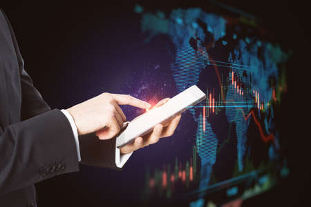 Close up of businessman hand pointing at cellphone with abstract glowing blue business forex chart...