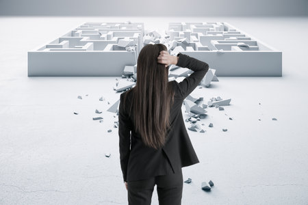 Back view of businesswoman in suit looking at white maze. Solution and challenege conceptの写真素材