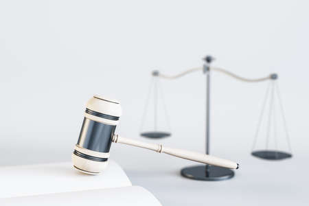 Close up of white gavel, scales and book / journal on light backdrop. Lawyer, justice and punishment concept. 3D Renderingの写真素材