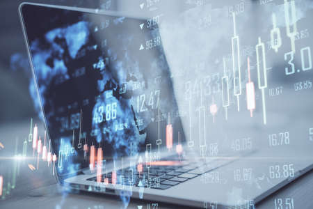 Close up of laptop computer with map, creative glowing big data forex chart candlestick hologram on...