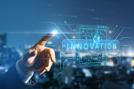 Close up of businessman hand pointing at abstract glowing innovation hologram on blurry night city background. Future and technology concept. Double exposureの写真素材
