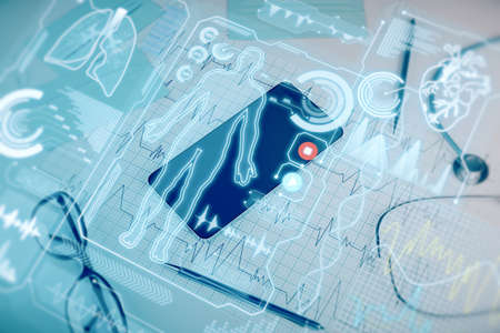 Close up of workplace with cellphone, supplies, stethoscope, glowing blue medical interface....