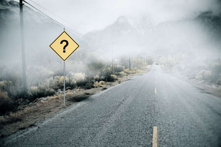 Creative misty road with question mark road sign and mock up place. Future and challenge conceptの写真素材