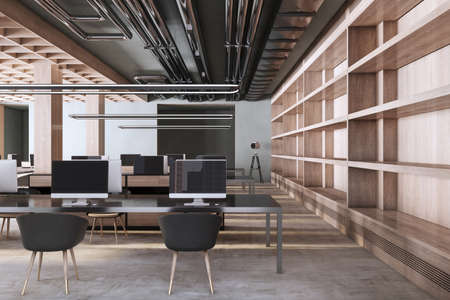 Luxury concrete and wooden co-working office interior with empty computer screens, equipment, furniture and daylight. 3D Renderingの写真素材