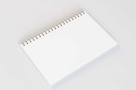 Close up of empty white spiral notepad on light desktop background. Mock up, 3D Rendering