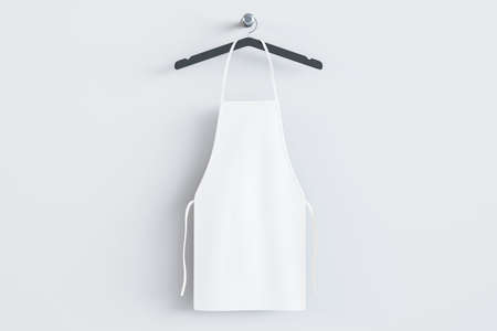 Empty white kitchen apron on hangers. light background. Chef and cooking concept. mock up place. 3D Renderingの写真素材
