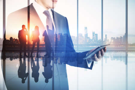 Abstract image of businessman using smartphone in modern office interior with panoramic city view,...