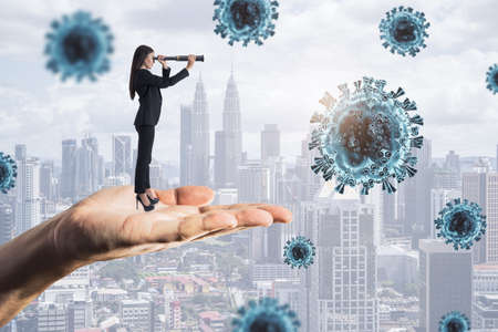 Abstract hand holding businesswoman looking into the distant future on daylight city background with...