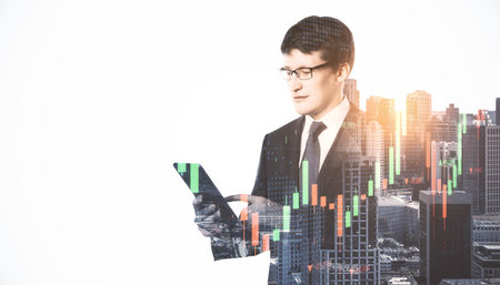 Portrait of handsome young european businessman using smartphone on bright city background with mock...