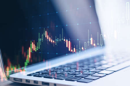 Close up of laptop computer with forex chart grid big data hologram on blurry background. Finance...