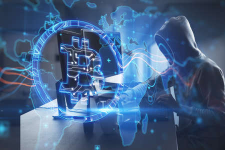 Side view of hacker at desktop using laptop with creative glowing global bitcoin hologram on blurry...
