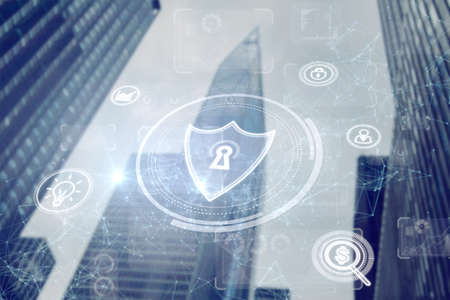 Abstract polygonal shield hologram on blurry city background. Antivirus and access concept. double exposureの写真素材