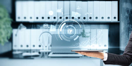 Close up of hand holding tablet with abstract glowing business hologram on blurry office interior...