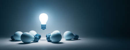 Creative illuminated lamps on wide gray background with mock up place. Idea, teamwork and leadership...
