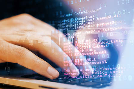 Close up of male student hand using laptop keyboard with abstract html code on creative city...