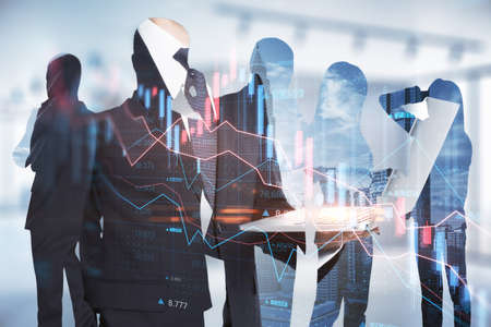 Attractive european businessmen using devices on abstract office workspace background with forex chart. Teamwork, crisis and collapse concept. double exposureの写真素材