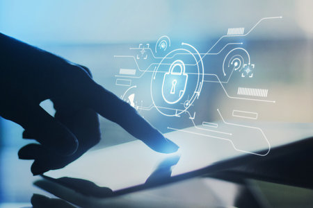 Close up of backlit female hand using tablet with abstract internet safety and security interface...