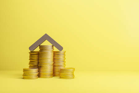 Abstract yellow mortgage background with coin house and mock up place. Loan, bank and money concept. 3D Renderingの写真素材