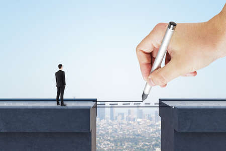 Pensive businessman looking at abstract pencil drawing road gap on bright sky background. trust and way conceptの写真素材