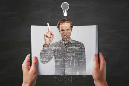 Hands holding open notepad with abstract caucasian businessman outline filled with mathematical...