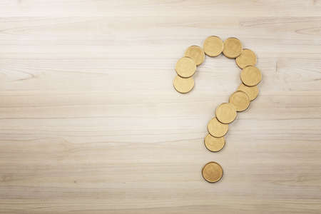 Abstract creative golden coin question mark on wooden surface backdrop with mock up place. Money,...