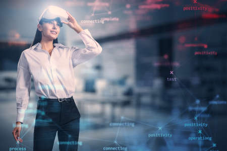 Attractive young european businesswoman with VR glasses and creative process stages mesh on blurry...
