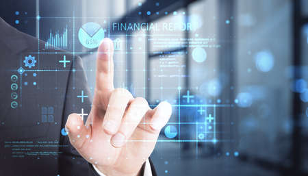 Close up of male hand pointing at abstract glowing blue financial report hologram on blurry bokeh...