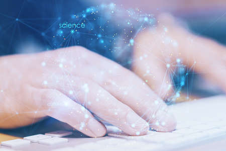 Close up of hands using keyboard on office desktop with creative digital linear sphere on blurry background. Global network and communication concept. double exposureの写真素材