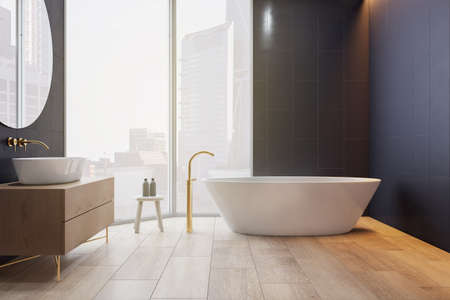 Modern light bathroom interior with dark wall wooden floor and sink base cabinet, white oval bath...