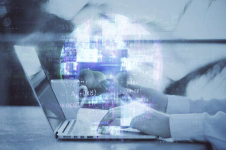 Close up of hands using laptop keyboard with human skull hologram. Web danger, hacking and phishing...