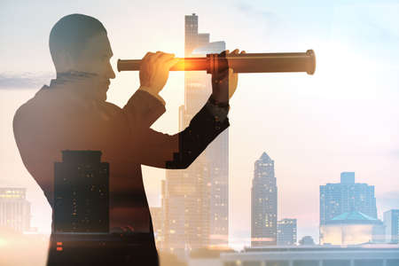 Abstract silhouette of businessman with telescope looking into the distance on bright city...