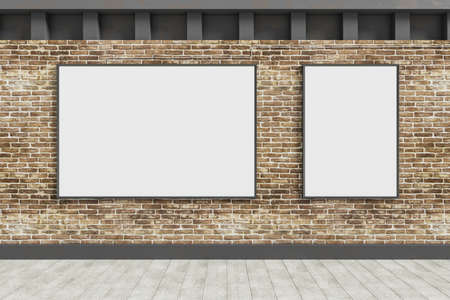 Empty white banners hanging on brick outdoor wall with shadows and sunlight. Billboard, commercial...