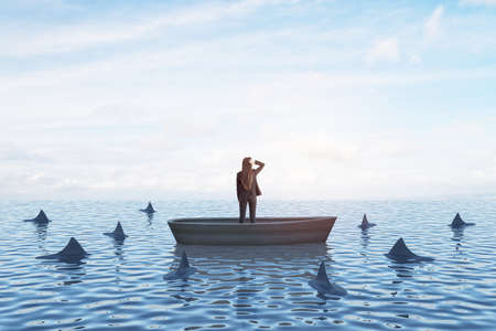Strategy, leadership and competition concept with back view on businesswoman looking In the distance in a boat in the sea with sharksの写真素材