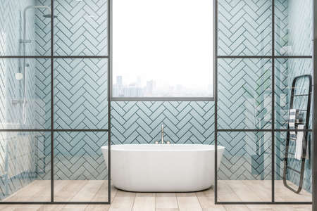 Front view on stylish white bath with metallic faucet under the window with city view, black modern towel rail and glass partitions in sunny bathroom. 3D renderingの写真素材