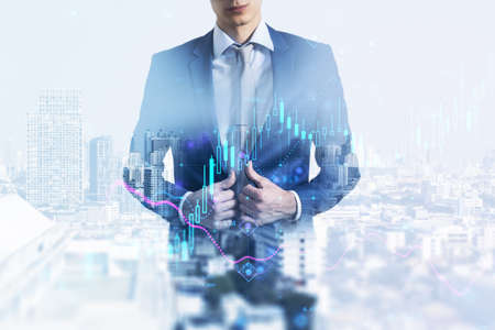 Stock market and investing concept with double exposure of businessman on city background and digital financial candlestick and graphsの写真素材