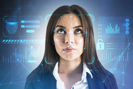 Portrait of thoughtful european businesswoman with face id glowing interface. Access, identification and recognition concept. double exposureの写真素材