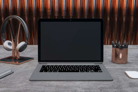 Close up of contemporary designer desktop with empty black laptop screen with headset, pencils and...
