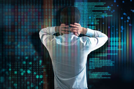 Back view of worried young european businessman with hands on neck standing on abstract glitching...