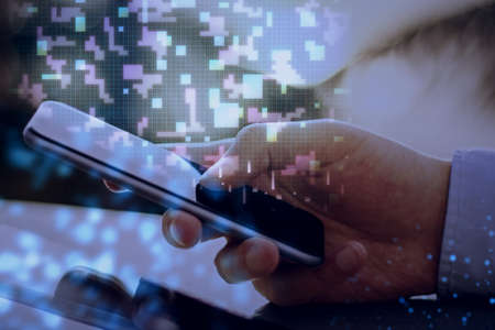 Close up of hand using mobile phone with digital metaverse pixel hologram on blurry background....