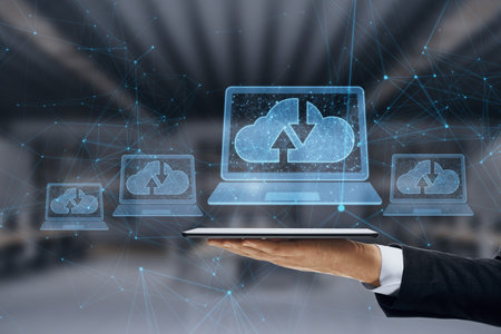 Close up of businessman hand holding tablet with abstract polygonal digital laptop with cloud...