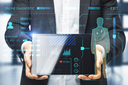 Close up of businessman hands holding tablet with creative glowing medical interface hologram on blurry interior background. Medicine, online technology and future healthcare concept. double exposureの写真素材