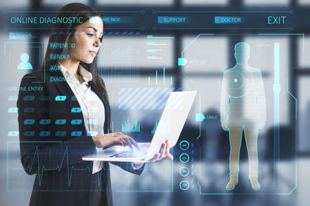 Attractive young european businesswoman or doctor with laptop and creative glowing medical interface hologram on blurry interior background. Medicine, online technology and future healthcare concept. double exposureの写真素材