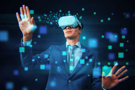 Attractive young european man using VR glasses on abstract blurry blue pixels background. Augmented...