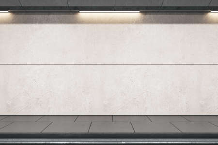 Front view on light gray blank wall for advertising billboard in empty metro station with rails and...