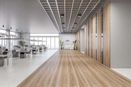 Front view on wooden and concrete floor area in modern open space office with lounge sofa, rows of...