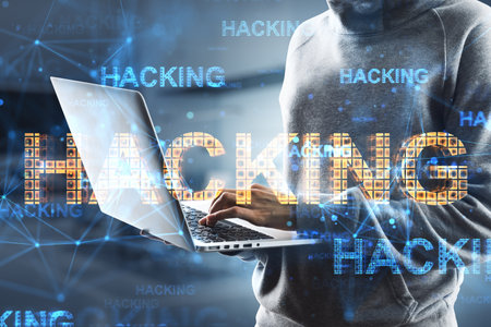 Close up of hacker hands using laptop with abstract glowing hacking hologram on blurry office...
