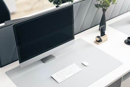 Close up and top view of creative white designer workplace with blank mock up computer screen with...